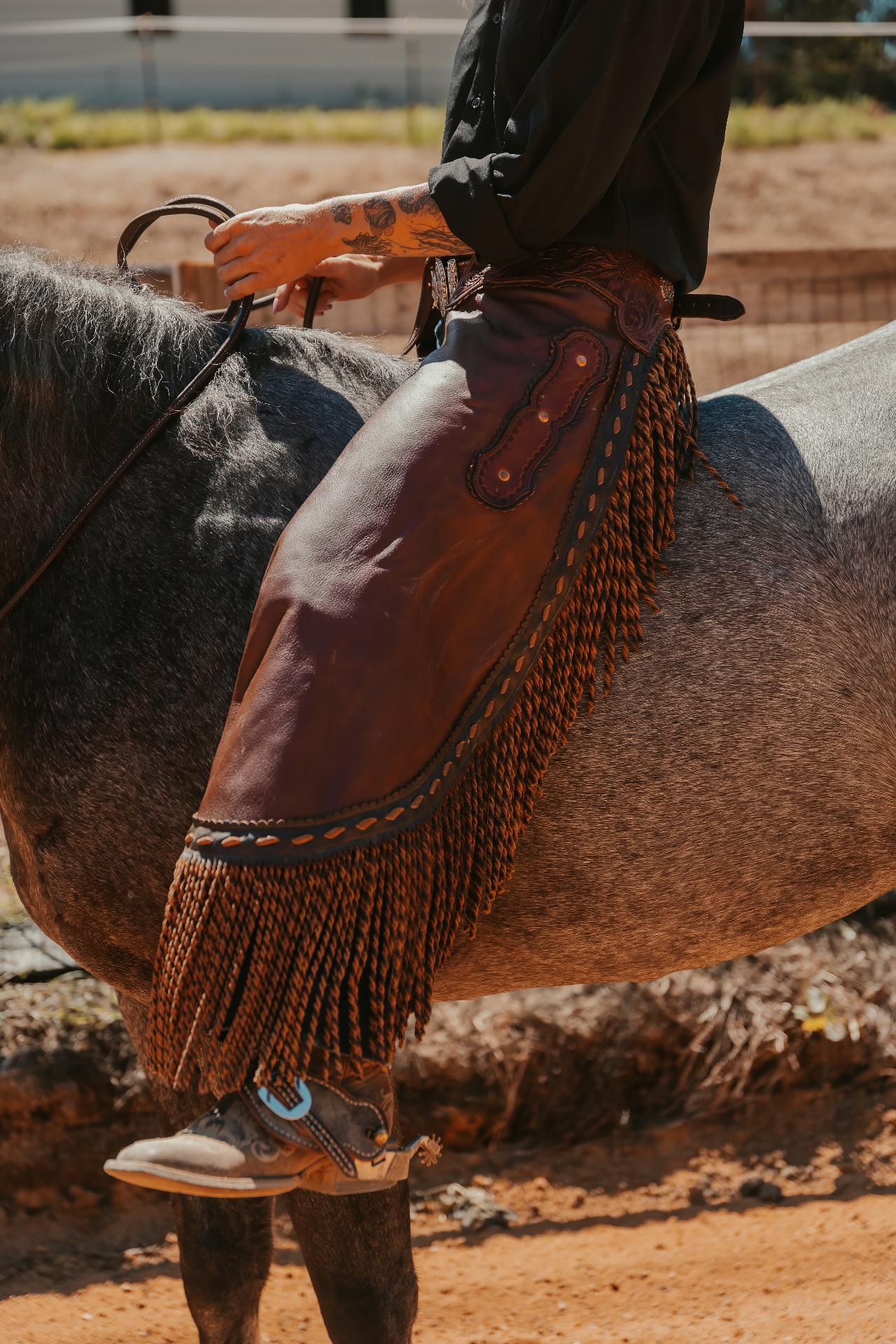 Custom leather chaps with fringe on horseback